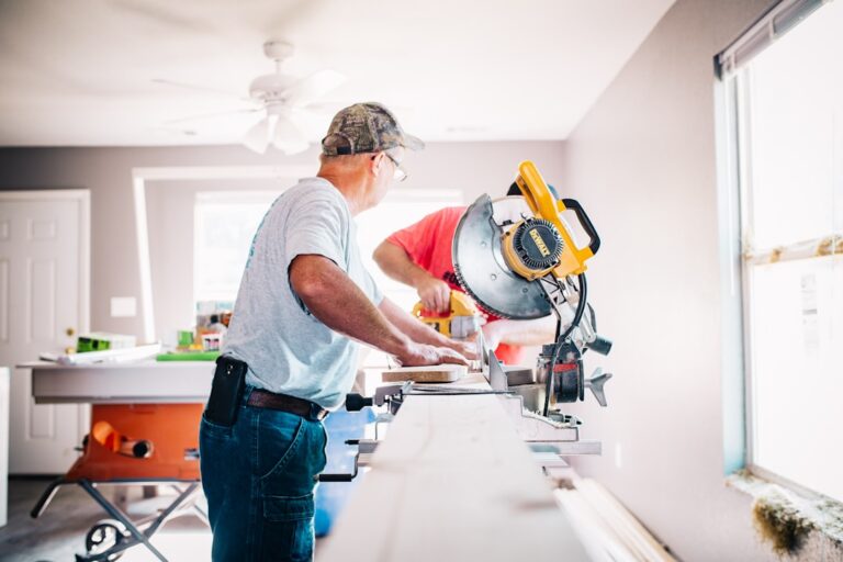 A homeowner reviews a contractor's license and insurance documents at a kitchen counter.