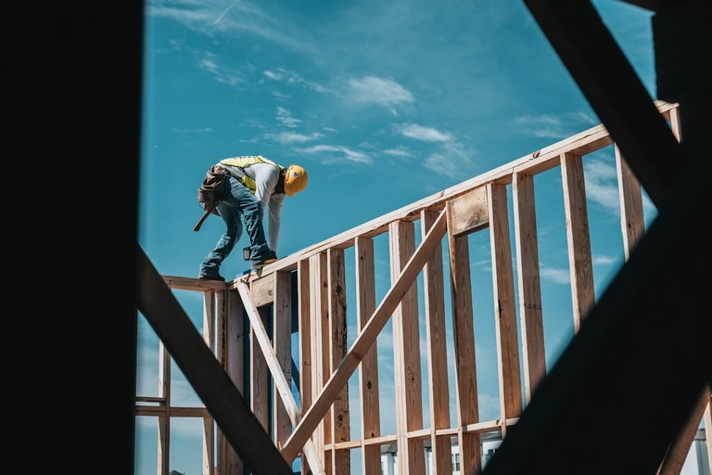 A city inspector reviews construction plans with a homeowner at a residential building site.