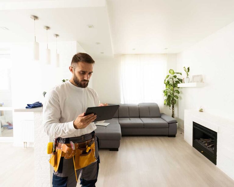 A family sitting together in a partially renovated living room with plastic sheets sectioning off work areas.